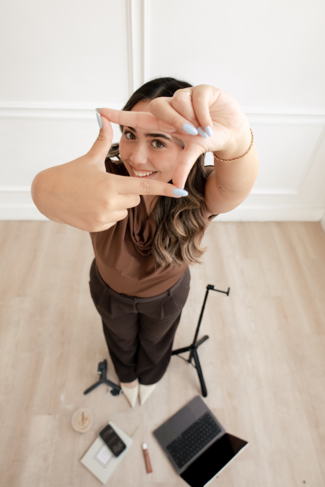 Playful overhead portrait of Valeria reaching toward the camera